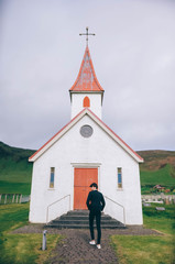 Man walking in the suit in front of the church