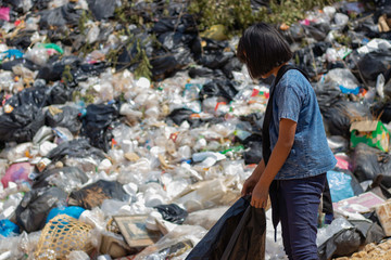 Children find junk for sale and recycle them in landfills, the lives and lifestyles of the poor, Child labor, Poverty and Environment Concepts