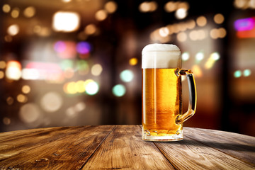 Fresh cold beer in glass and free space for your bottle. Bar interior background 