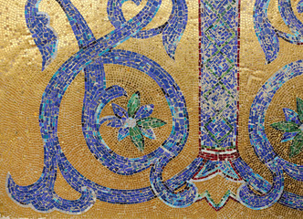 Mosaic fragment. Floral ornament blue on a golden background.