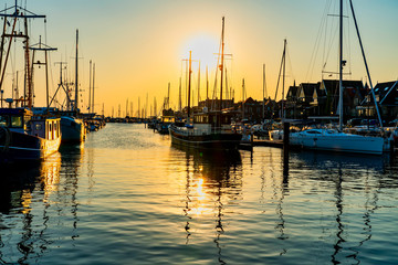 Harbor of the idyllic y small fisher town Urk with wonderful evening light - obrazy, fototapety, plakaty