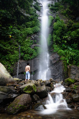 Beautiful scene of Semirang Waterfall with lovely smooth water. A man standing and enjoying a gorgeous waterfall. A Waterfall which is a tourist destination in the city of Ungaran