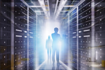 Man with laptop in server room interior