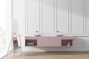 Double bathroom sink near white wall