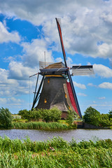 Netherlands rural lanscape with windmills at famous tourist site Kinderdijk in Holland. Old Dutch village Kinderdijk, UNESCO world heritage site. 