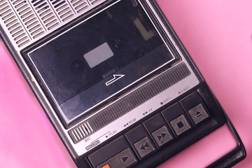 Old retro vintage 70s, 80s, 90s style portable  audio  tape cassette  recorder radio  on a pink background top view