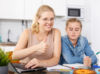 Girl and her mother doing home task