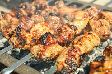 Meat skewers on grill as background, closeup. Outdoor kitchen