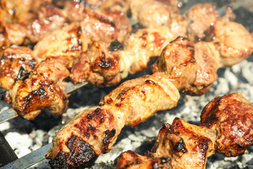 Meat skewers on grill as background, closeup. Outdoor kitchen