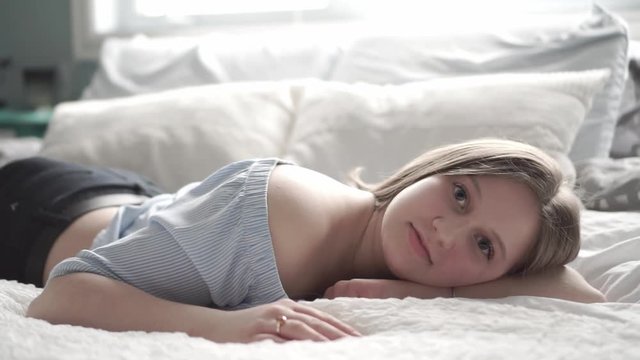 A teenage girl lying in bed and relaxing