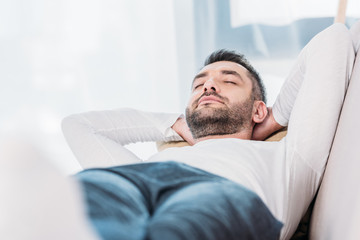 selective focus of handsome bearded man resting with eyes closed
