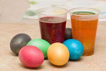 dyeing multicolored easter eggs in coloring solutions