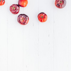 Tomatoes Mar Azul on white wooden table background