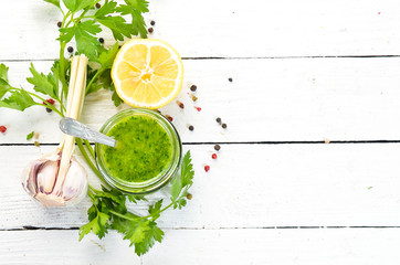 Green parsley sauce, Ingredients for chimichurri sauce. On a white wooden background. Top view. free space for your text.