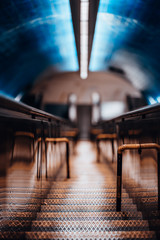 Long narrow iron stairway stretching deeper underground to a metro station as an additional way between two escalators, picturesque colors shallow depth of field, selective focus on metal steps