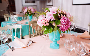 Beautiful bright bouquet of peony on the wedding table in vase