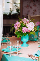 Beautiful bright bouquet of peony on the wedding table in vase