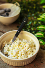 cottage cheese with berries in a plate on the table, healthy food (a portion of vitamin food). food background. top view