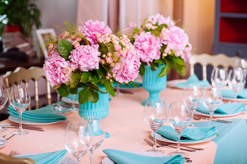 Beautiful bright bouquet of peony on the wedding table in vase
