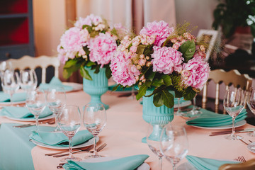 Beautiful bright bouquet of peony on the wedding table in vase