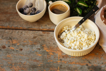 cottage cheese with berries in a plate on the table, healthy food (a portion of vitamin food). food background. top view