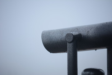 Binoculars to observe the sights on a background of white fog.