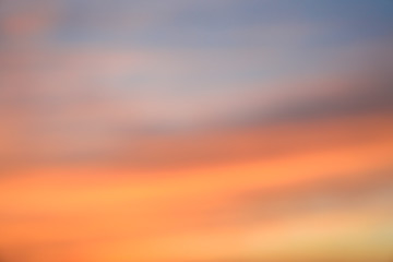 Dramatic sunset sky background with fiery clouds, yellow, orange and pink colour, nature background. Blurred background