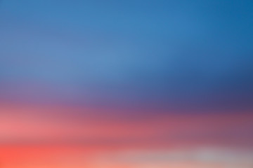 Dramatic sunset sky background with fiery clouds, yellow, orange and pink colour, nature background. Blurred background