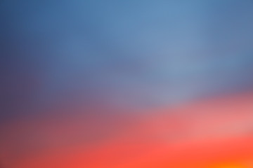 Dramatic sunset sky background with fiery clouds, yellow, orange and pink colour, nature background. Blurred background