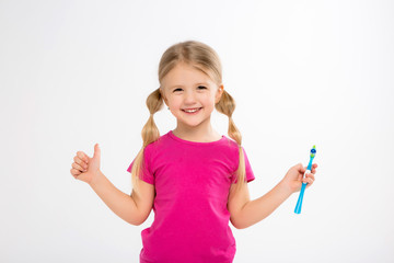Happy little girl standing with toothbrush isolated on white.little child brush his teeth.Cute little girl is brushing teeth with a smile.dental hygiene. happy little girl brushing her tooth