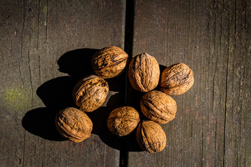 unopened walnuts, with wooden bottom and green trees