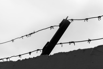 The barbed wire with gray sky. concept of war and military base.