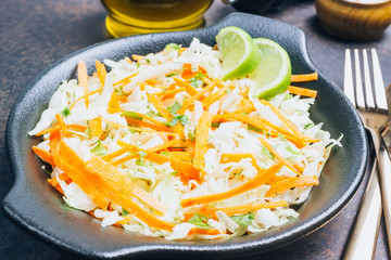 Fresh coleslaw salad in black plate