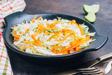 Fresh coleslaw salad in black plate