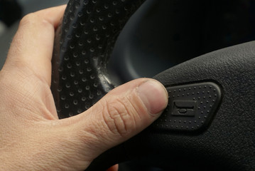 Nervous driver pushing car horn on steering wheel 