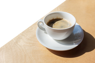 Fresh brewed coffee on wooden windowsill. Coffee white cup on wooden table. coffee and caffeine addiction problem concept.