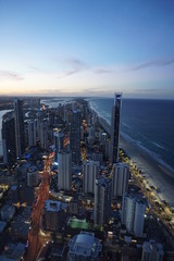 Fototapeta na wymiar Skyline of Gold Coast, Brisbane, Australia after sunset, with both skyscrapers and beach in the foreground, as well as the sea in the horizon