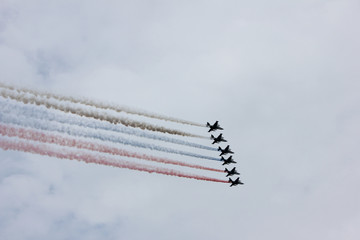 Military planes making tricolor sign in the sky in the form of russian flag in St. Petersburg, Russia 