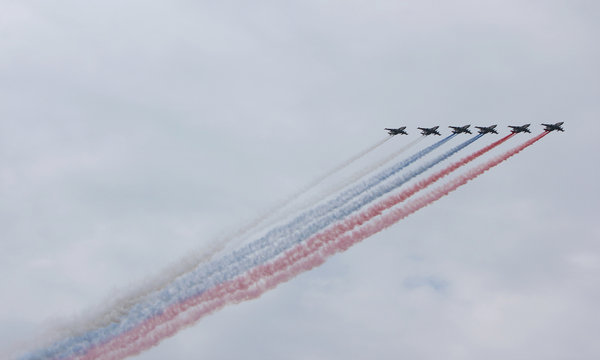 Planes making tricolor smoke trail at airshow in Saint Petersburg, Russia