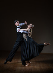 Beautiful young dancers in ballroom isolated on black background