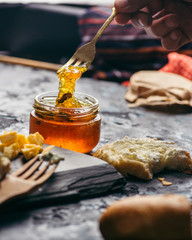 Fruit jams and marmalades with various cheeses on a plate. Breakfast with coffee and cheese