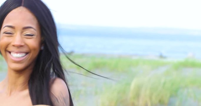 Pretty woman with long black hair smiling and laughing