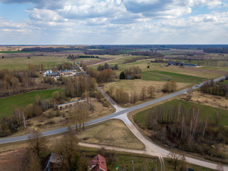 Fototapeta na wymiar aerial view of country roads and small village with houses and lake