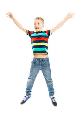A boy in a bright T-shirt jumping. Vertical. Isolated on a white background.