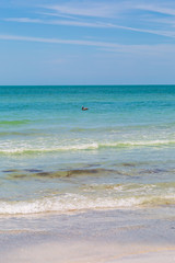 Looking out to sea from Redington Shores in Florida, with a pelican on the water in the distance