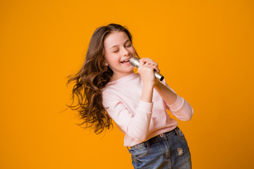 baby girl with microphone smiling singing,Fat girl singing song into microphone. Young star,...