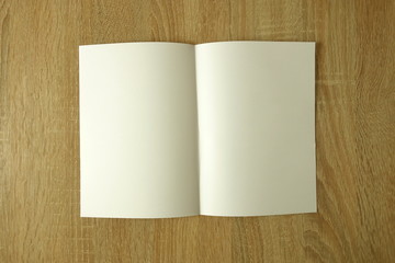 Blank book or brochure mockup on a wooden table