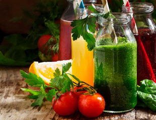 Food and drinks, selection of vegetable and fruit juices and smoothies in glass bottles with...