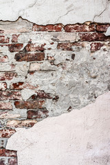 texture old brick wall with crumbling plaster and shattered, abstract background