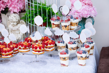 Buffet with sweets. Cakes with raspberries. Sweet table for banquets, weddings, parties.